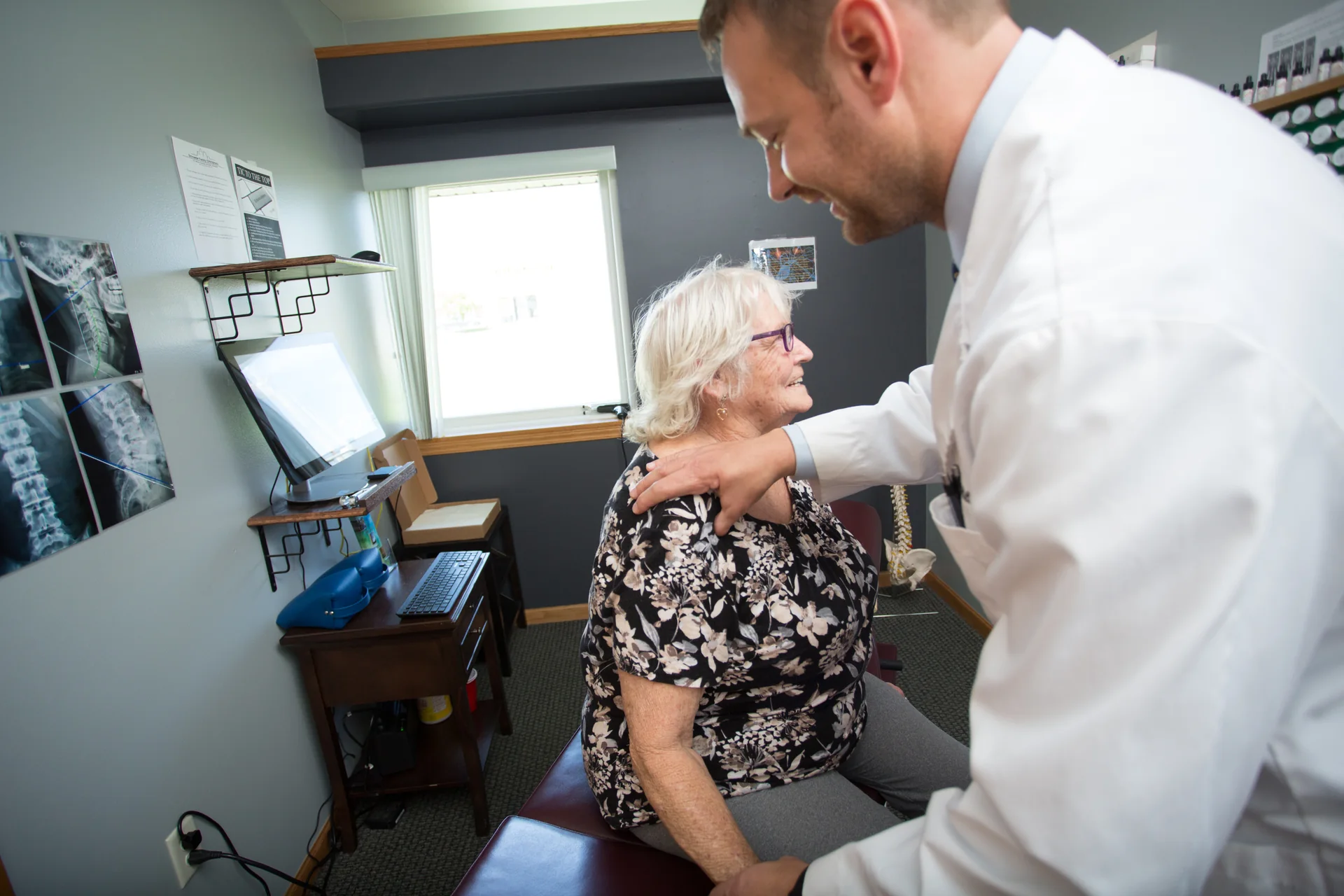 A clinician examining a shoulder